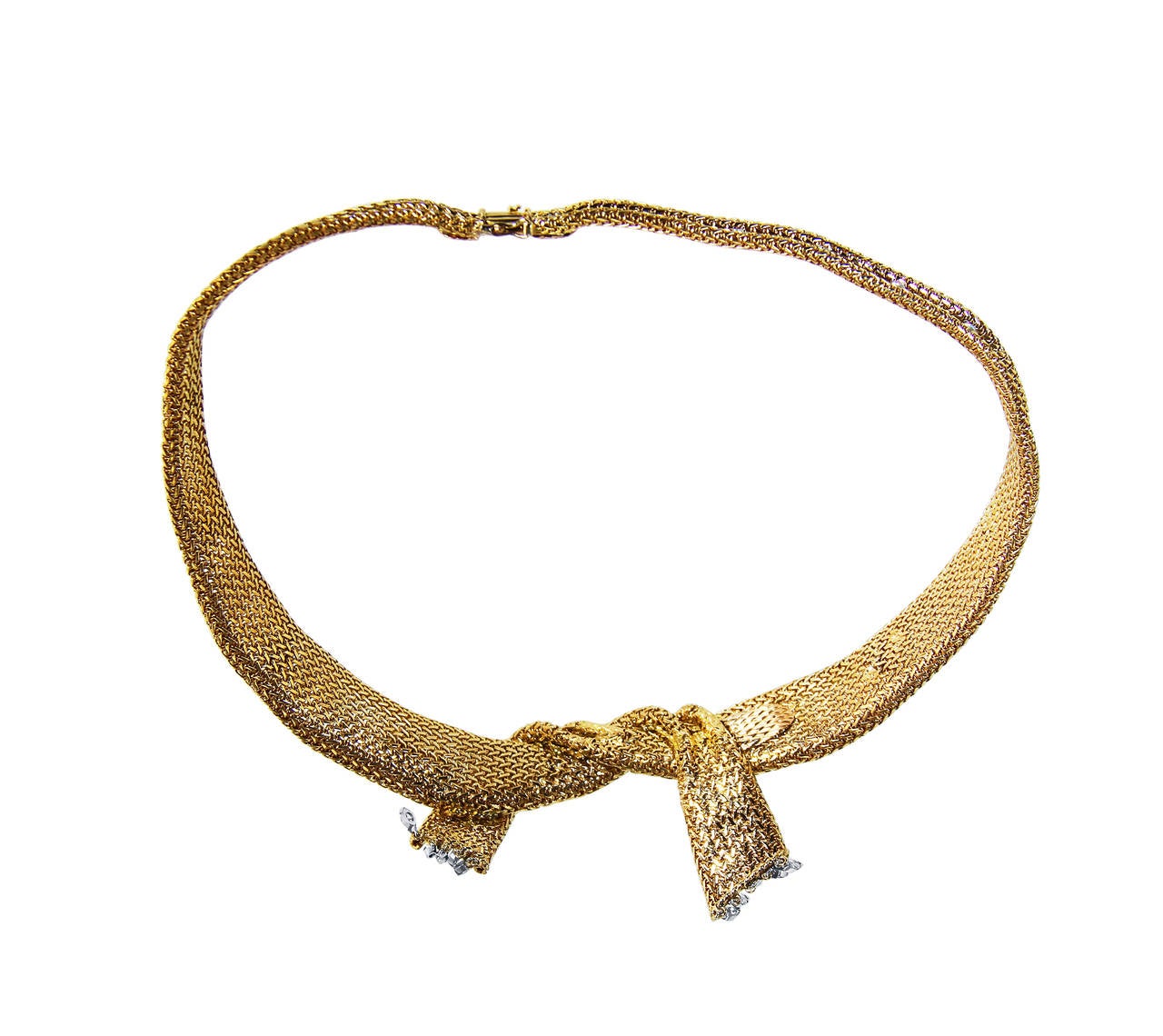 An 18 karat yellow gold and diamond collar necklace, circa 1950, France, the tapered collar designed as a golden mesh ribbon tied at the front, set throughout with 95 round diamonds weighing approximately 4.00 carats, accented by an articulated