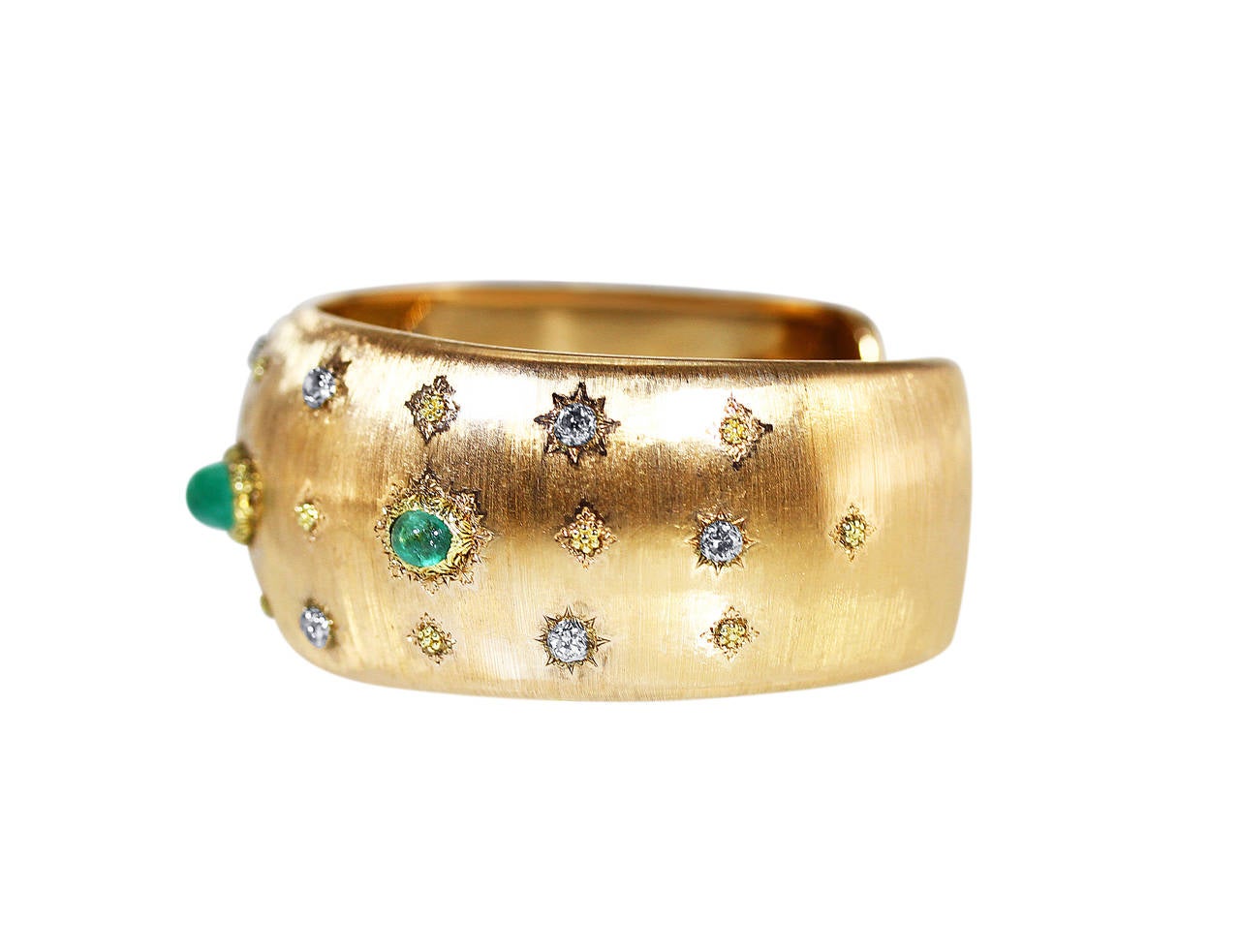 An 18 karat yellow gold, cabochon emerald and diamond cuff bracelet by Buccellati, Italy, of slightly tapered form with brushed gold detailing set with 3 cabochon emeralds weighing approximately 3.00 carats, accented by 10 single-cut diamonds