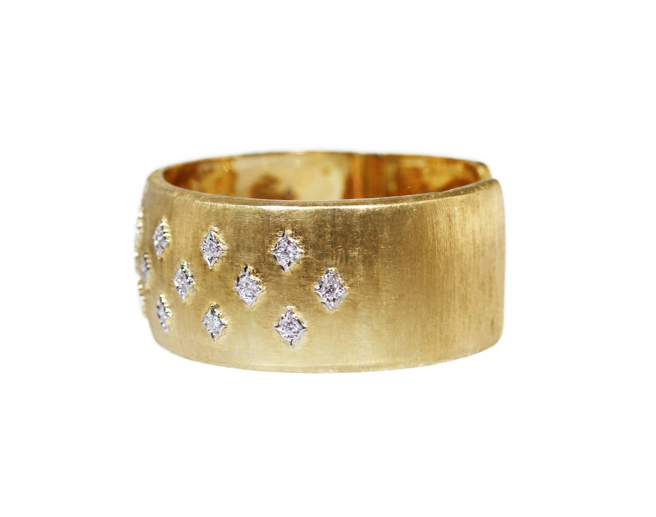 An 18 karat gold and diamond cuff bracelet by Buccellati, Italy, the wide cuff with textured gold finish accented by white gold plaques set with 25 round diamonds weighing approximately 1.00 carat, gross weight 64.7 grams, length 6 1/2 inches, width