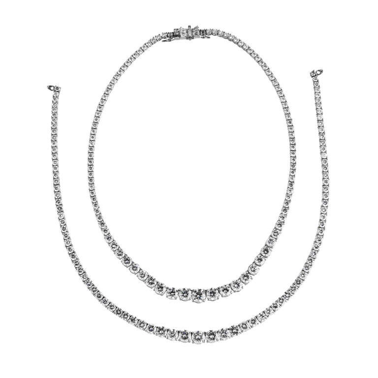 Platinum double strand rivière convertible necklace with one removable strand so it can be worn as a single line or double line necklace. This necklace contains 100 round diamonds in the longer necklace weighing approximately 26.00 carats and 89