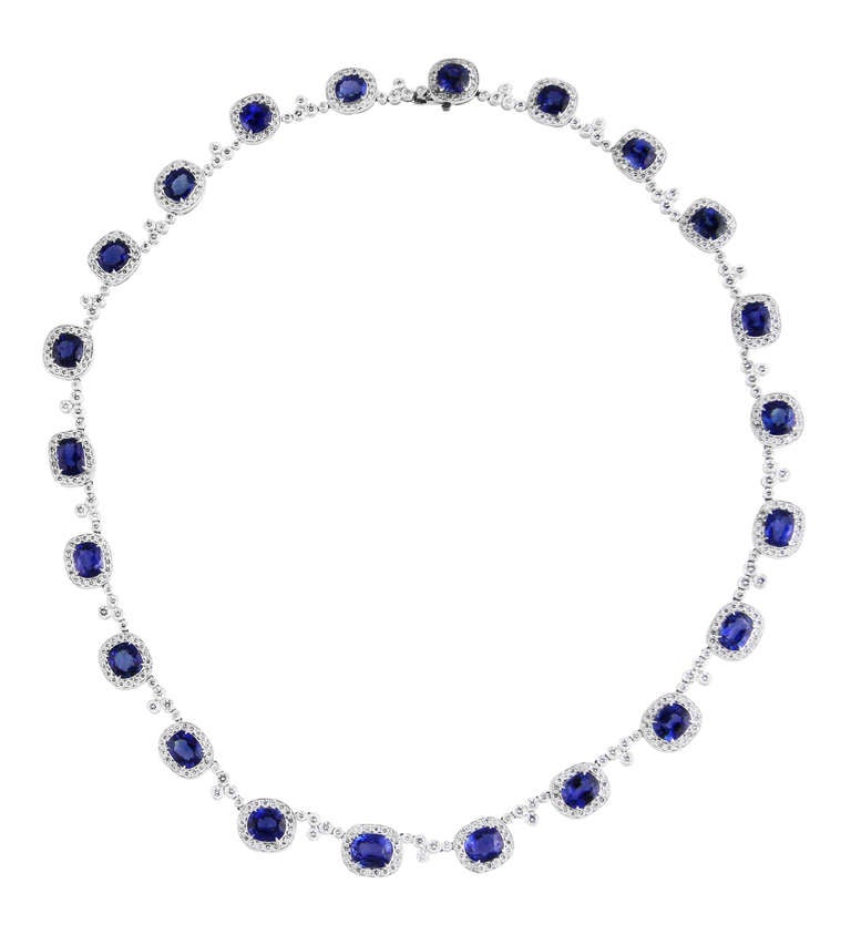 This beautifully made platinum necklace is set with a line of 22 oval blue sapphires weighing 29.78 carats, all within frames set with round diamonds and spaced by round diamonds weighing 7.73 carats, length 16 inches.
Accompanied by GRS report no.