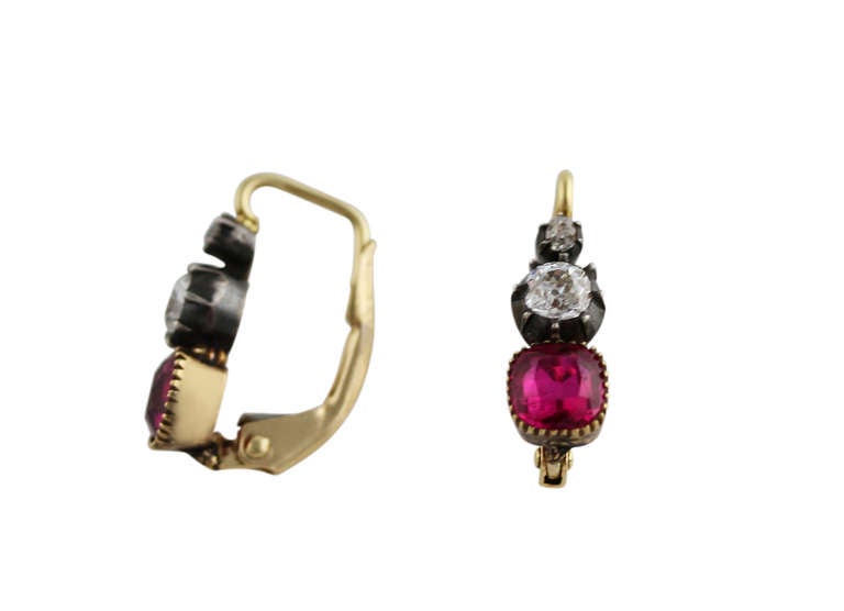 A Pair of silver-topped 18 karat yellow gold, ruby and diamond earrings, set with 2 well-matched cushion-shaped rubies weighing approximately 2.20 carats, Burma no heat, and 4 old mine-cut diamonds weighing approximately 0.45 carat, gross weight 3.2