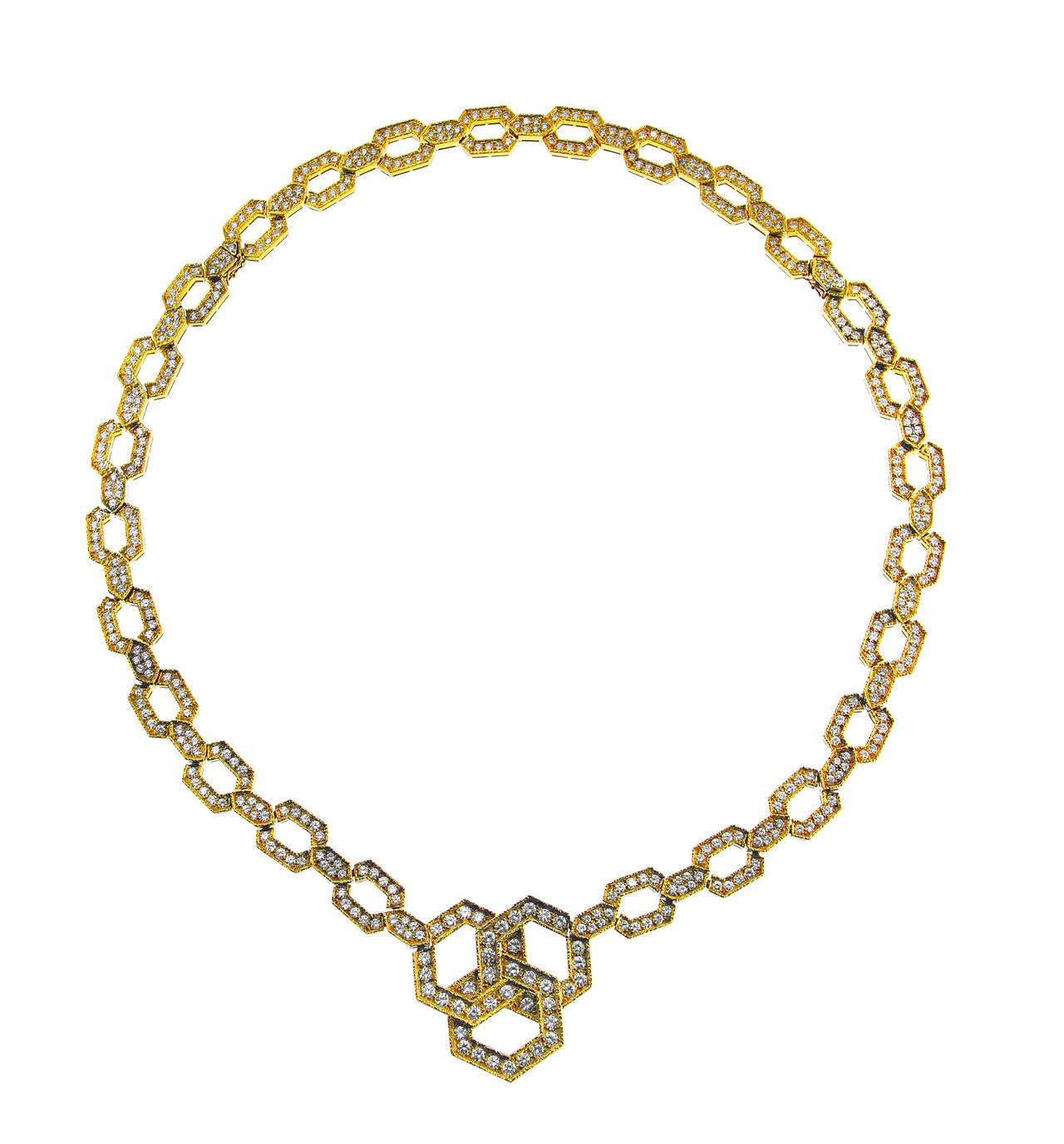 An 18 karat yellow gold and diamond necklace/bracelet combination by Van Cleef & Arpels, circa 1980s, designed as a series of geometric links completed by a larger interlocking link section at the center, set throughout with 262 round diamonds
