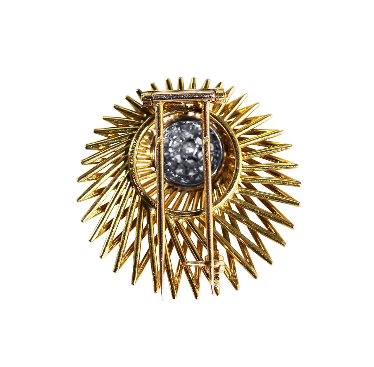 An 18 karat yellow gold, platinum and diamond 'Meteor' brooch by Van Cleef & Arpels, France, circa 1970, designed as a sunburst of polished gold tendrils set in the center with a bombe plaque set with 37 round diamonds weighing approximately 2.25