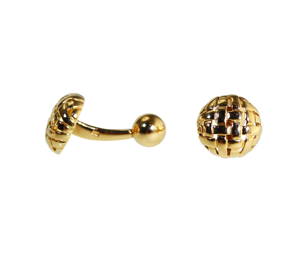 A pair of 18 karat yellow gold weave cufflinks by Tiffany & Co., 1995, the teriminals designed as polished gold woven circles, gross weight 12.3 grams, measuring 1 1/8 by 5/8 inches, signed T & Co., c 1995, stamped 750, with signed pouch.