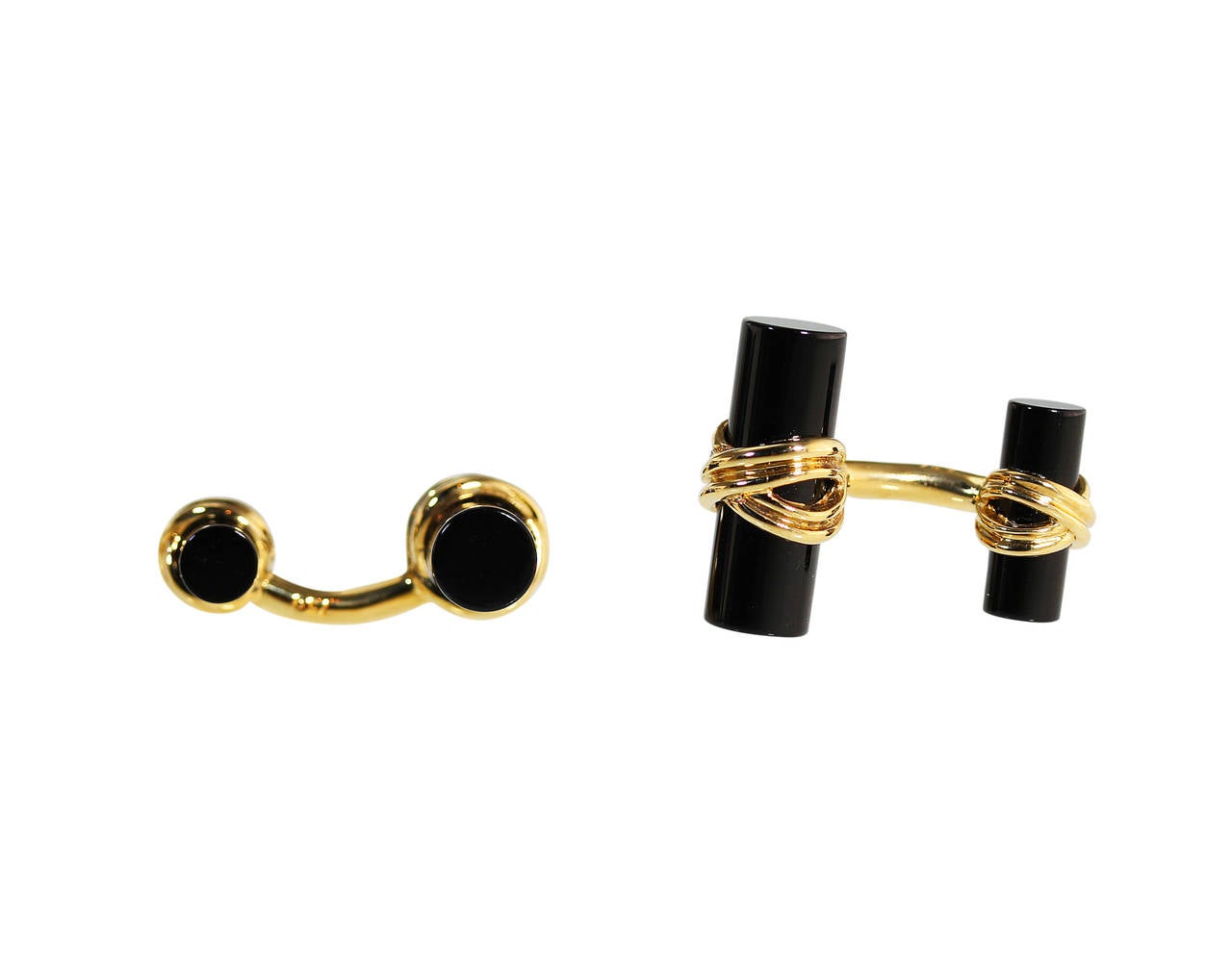 A pair of 18 karat yellow gold and onyx cufflinks by Tiffany & Co., the terminals composed of carved onyx circular bars wrapped in polished gold, gross weight 13.5 grams, measuring 1 by 3/4 inches, signed Tiffany & Co., stamped 750, with signed