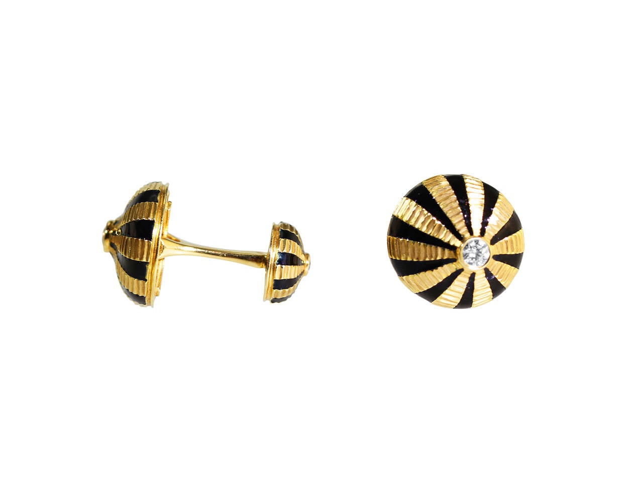 A pair of 18 karat yellow gold, diamond and black enamel cufflinks by Schlumberger for Tiffany & Co., the terminals of bombe form set in the centers with 4 round diamonds weighing approximately 0.55 carat, framed by radiating bands of black enamel,