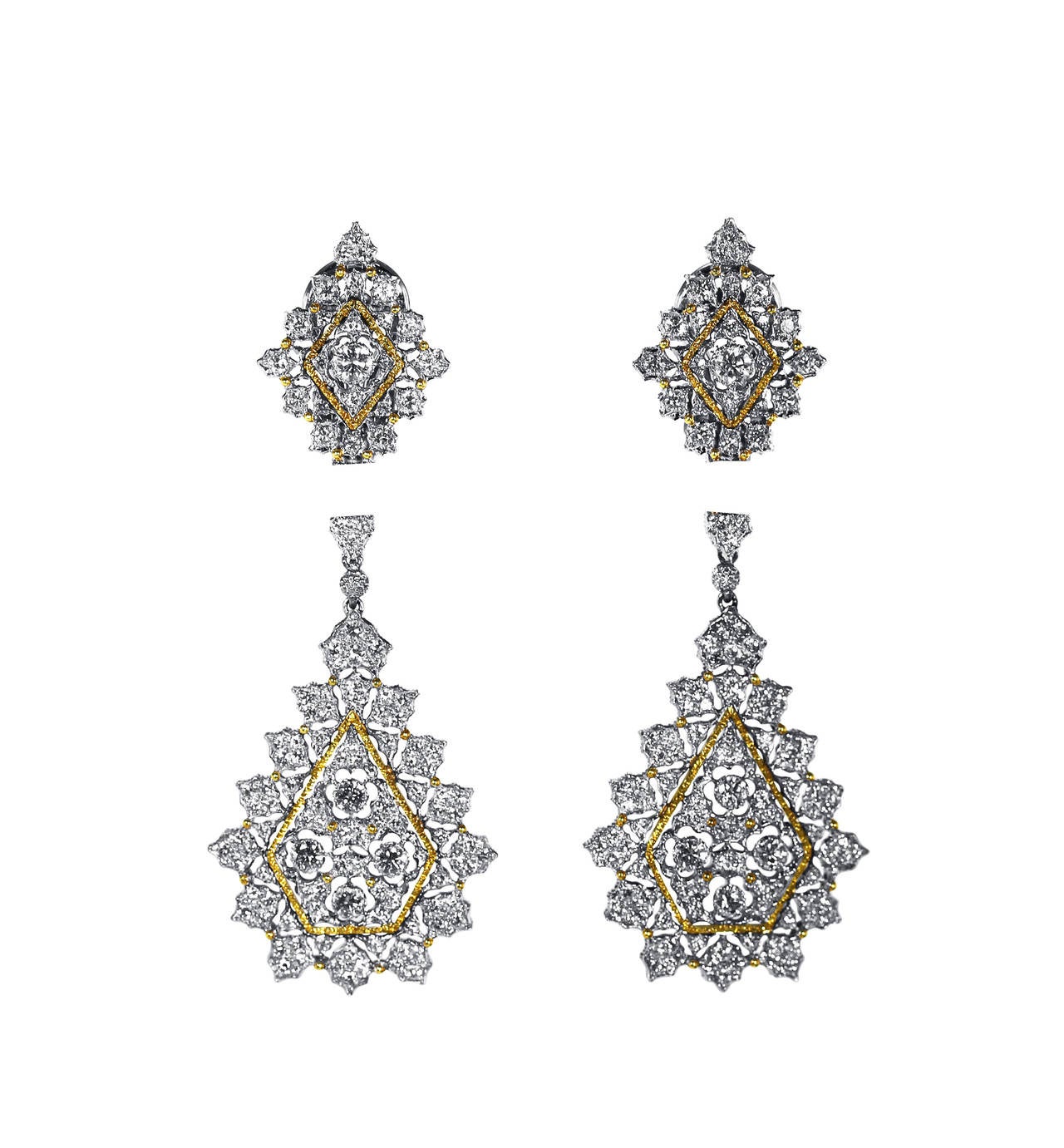 A pair of 18 karat white and yellow gold and diamond day and night pendant earclips by Buccellati, Italy, of honeycomb design set throughout with 246 round diamonds weighing approximately 4.00 carats, gross weight 19.5 grams, the pendants are
