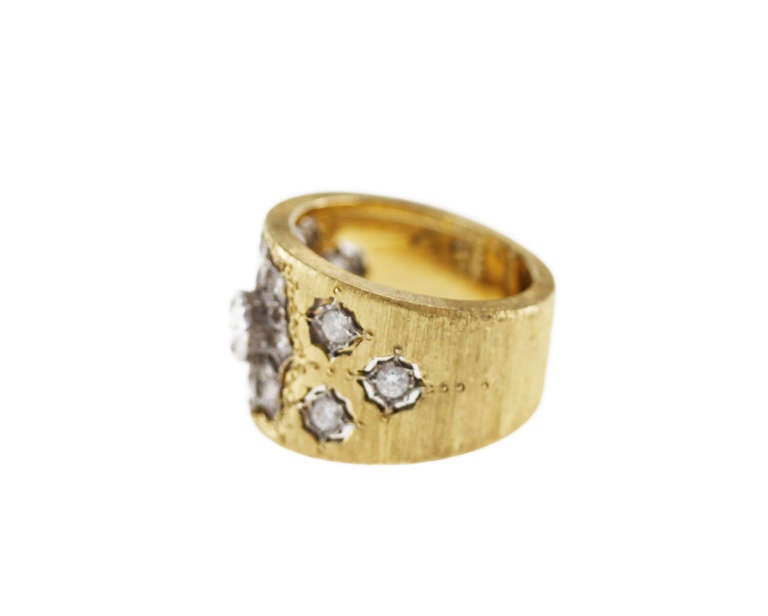 A beautifully made 18 karat white and yellow gold and diamond band ring by Buccellati, of slightly tapered design composed of brushed yellow gold, inset with openwork white gold plaques set with 15 round diamonds weighing approximately 1.00 carat,