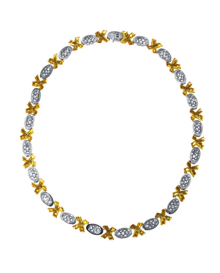 This beautiful 18 karat yellow gold, platinum and diamond necklace by Oscar Heyman & Brothers is designed as alternating gold 'x' links and oval bombe form platinum links set with 399 round diamonds weighing 17.85 carats, length 16 inches, width 3/8