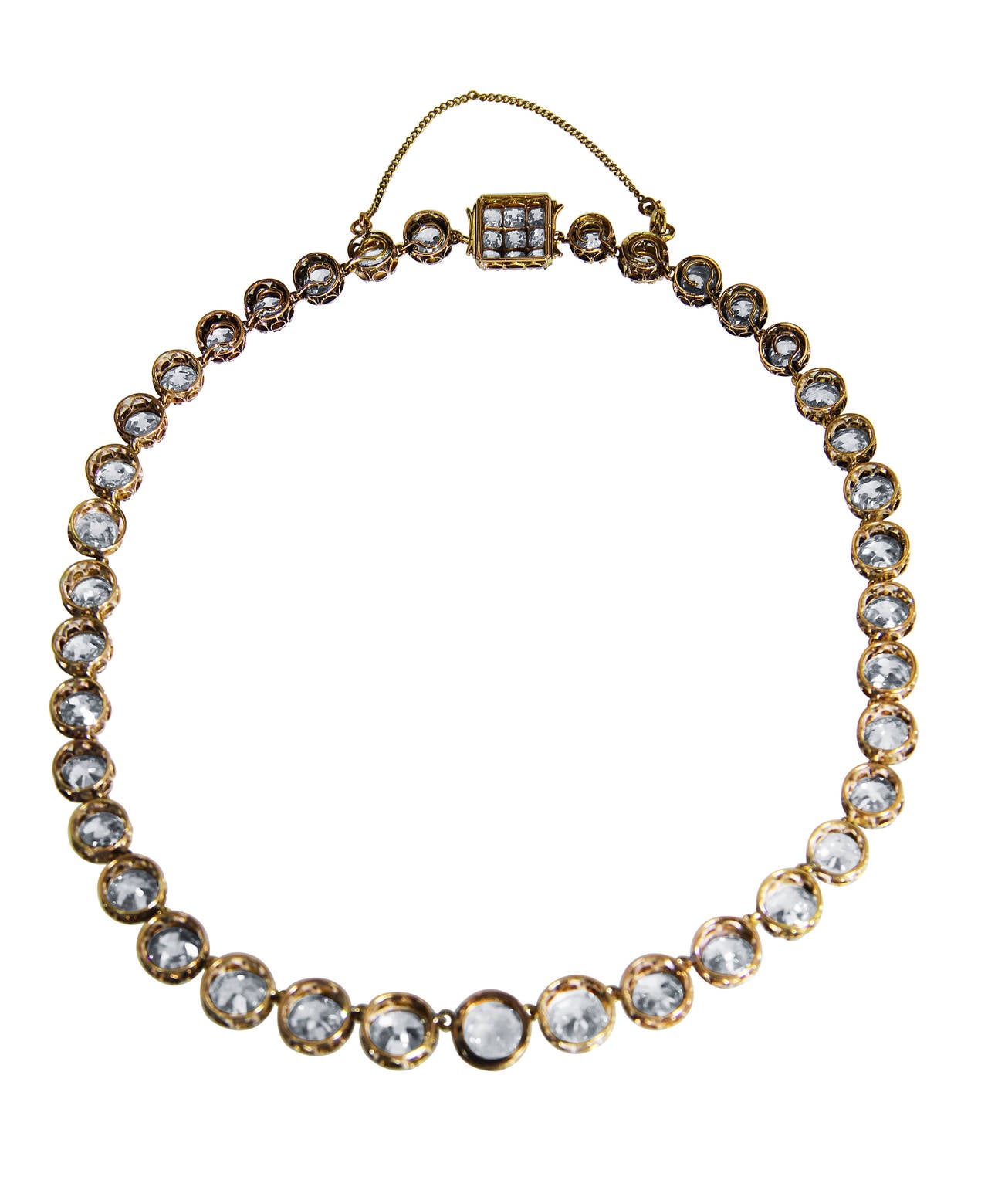 A stunning antique gold and silver diamond rivière necklace, of graduated design set with 47 old mine-cut diamonds weighing a total of approximately 45.00 carats, gross weight 28.3 grams, length 14 inches, clasp is removable from both sides.  This