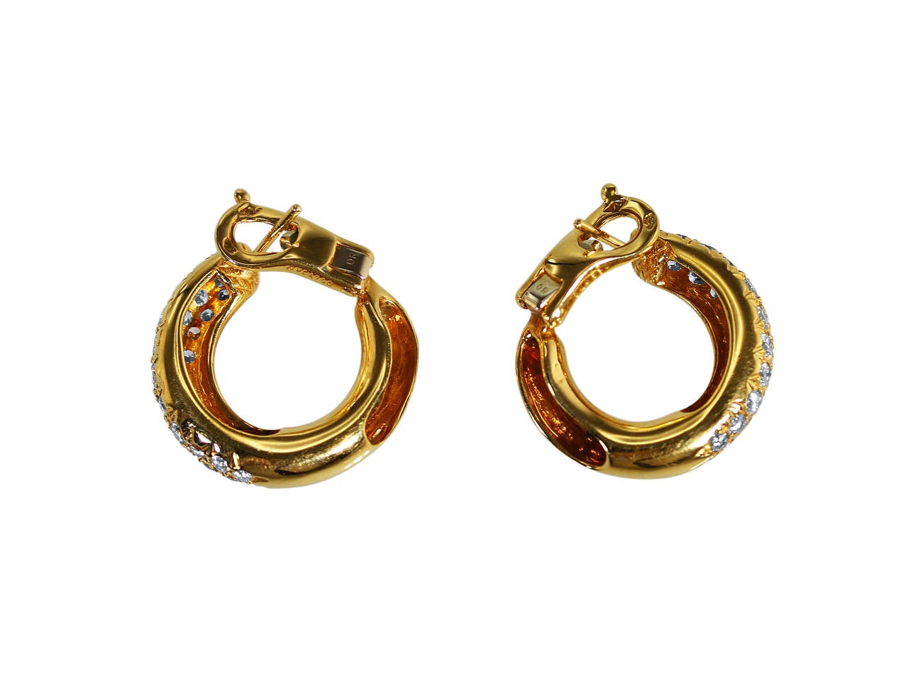 A pair of 18 karat gold and diamond hoop earrings by Van Cleef & Arpels, France, the fronts pavé-set with 68 round diamonds weighing approximately 1.50 carats, gross weight 9.2 grams, measuring 3/4 by 3/4 inch, signed VCA, numbered BL4633, marked