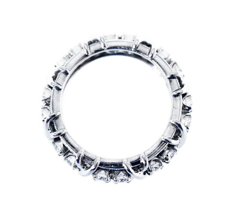 A platinum and diamond ring by Schlumberger for Tiffany & Co., of x design spaced by 16 round diamonds weighing approximately 1.60 carats, gross weight 11.0 grams, size 6 1/2, measuring 1 by 1/4 inches, signed Tiffany & Co., Schlumberger Studios,