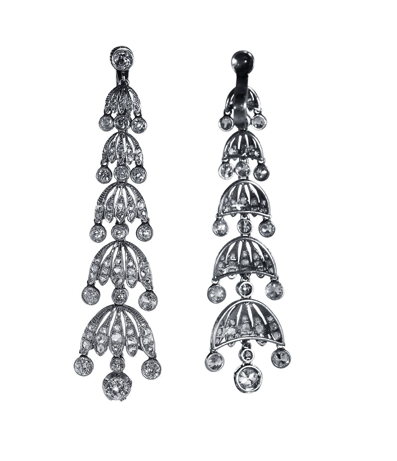 A pair of early 20th century platinum and diamond pendant-earclips, designed as graduated chandeliers set throughout with 34 old European-cut diamonds weighing approximately 5.50 carats, accented by 116 rose-cut diamonds weighing approximately 1.50