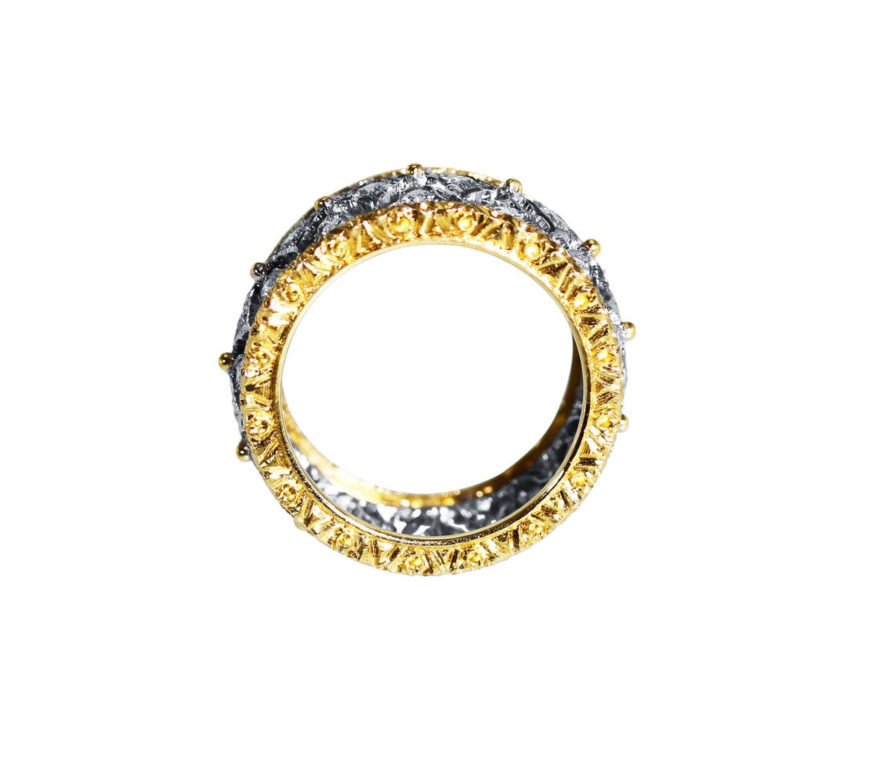 An 18 karat white and yellow gold and diamond band ring by Buccellati, Italy, the pierced openwork gold band set with 39 round diamonds weighing approximately 1.00 carat, gross weight 8.3 grams, size 6, signed M Buccellati, Italy, stamped 750.
