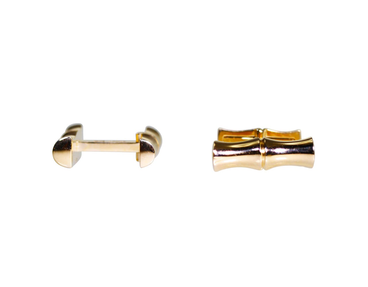 A pair of 14 karat yellow gold bamboo cufflinks by Tiffany & Co., the terminals designed as polished gold bamboo pieces, gross weight 14.3 grams, measuring approximately 7/8 by 1/4 by 7/8 inches, signed Tiffany & Co, stamped 14K.