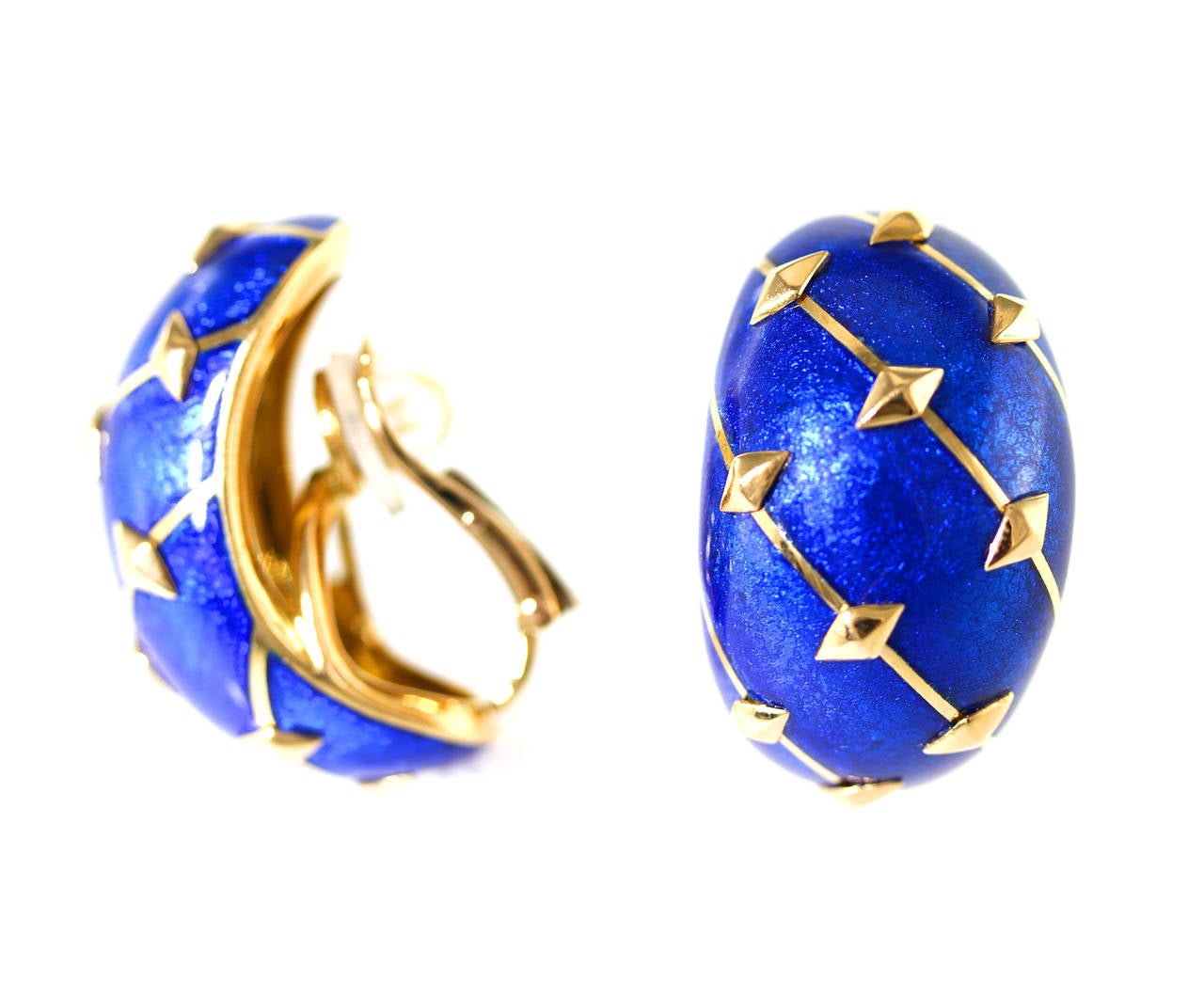 A pair of 18 karat yellow gold and blue Paillonne enamel earclips by Schlumberger for Tiffany & Co., designed as bombe half hoops applied with blue paillonne enamel accented by polished gold diagonal bands and diamond-shaped gold studs, gross weight