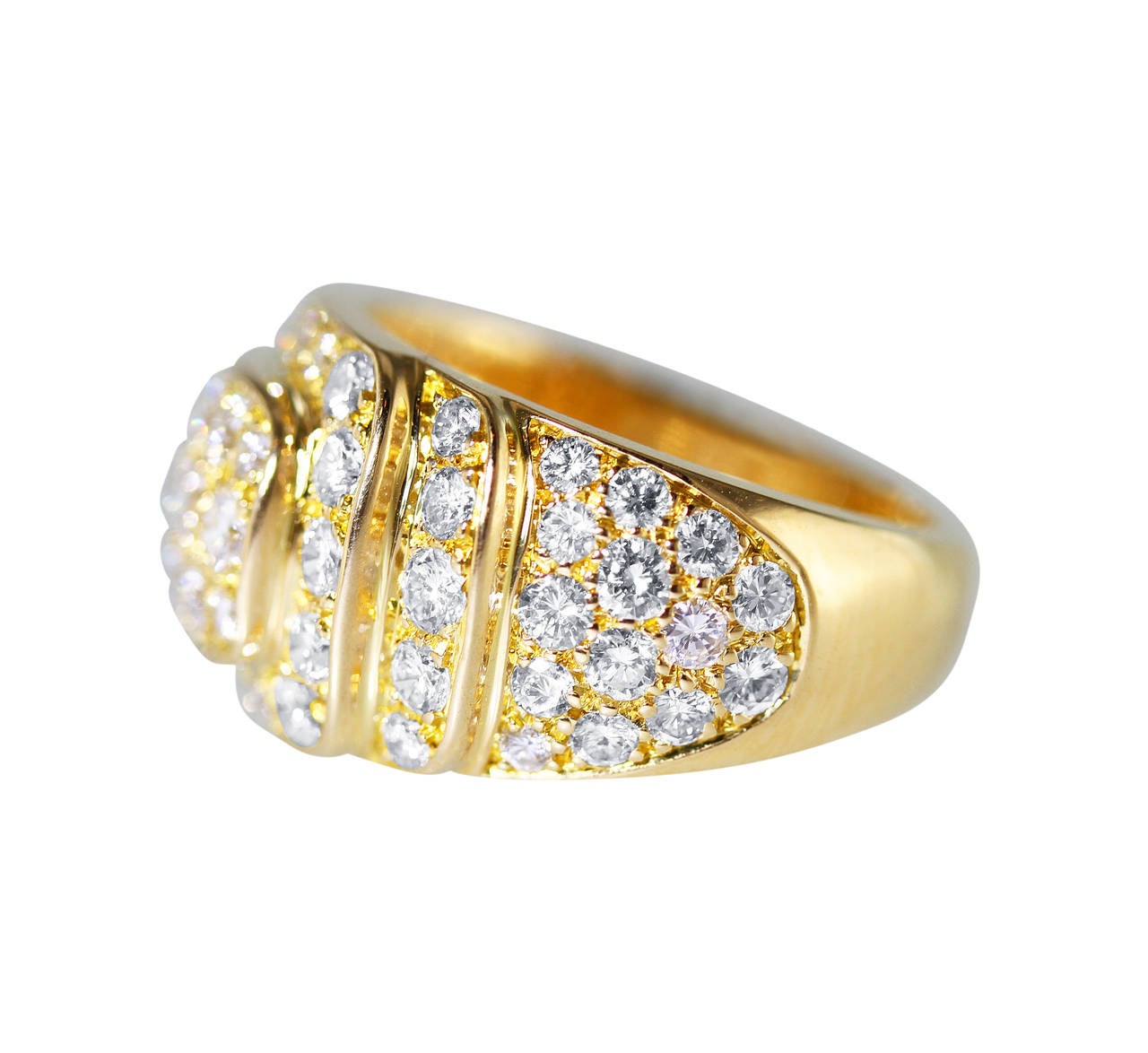 An 18 karat yellow gold and diamond ring by Van Cleef & Arpels, France, of tapered design set with 67 round diamonds weighing approximately 2.50 carats, gross weight 8.1 grams, size 5 3/4, measuring 3/4 by 1/2 by 7/8 inches, signed VCA, numbered