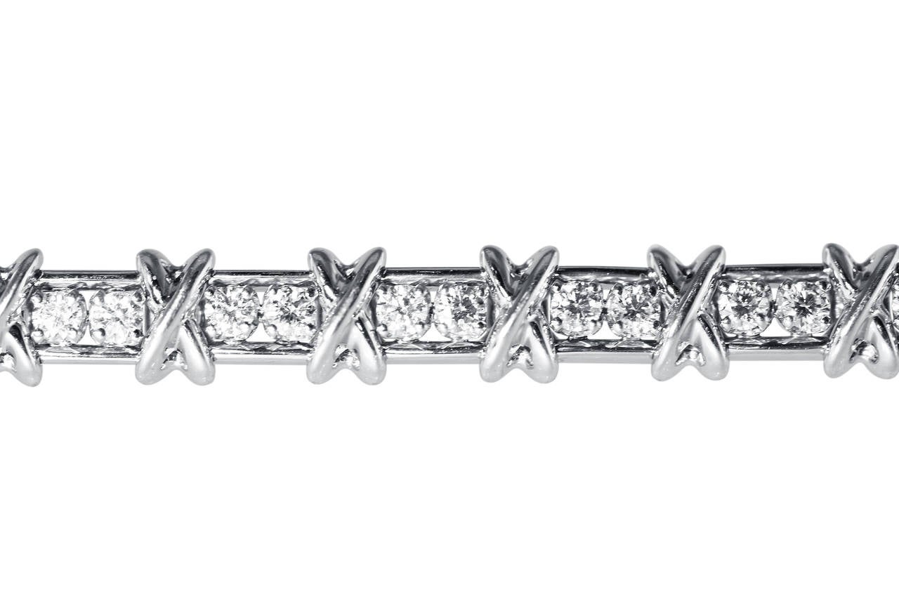 A platinum and diamond '36 Stone' bracelet by Schlumberger for Tiffany & Co., of straightline designed as series of polished platinum 'X' links spaced by 36 round diamonds weighing approximately 2.95 carats, gross weight 43.9 grams, length 7 1/4