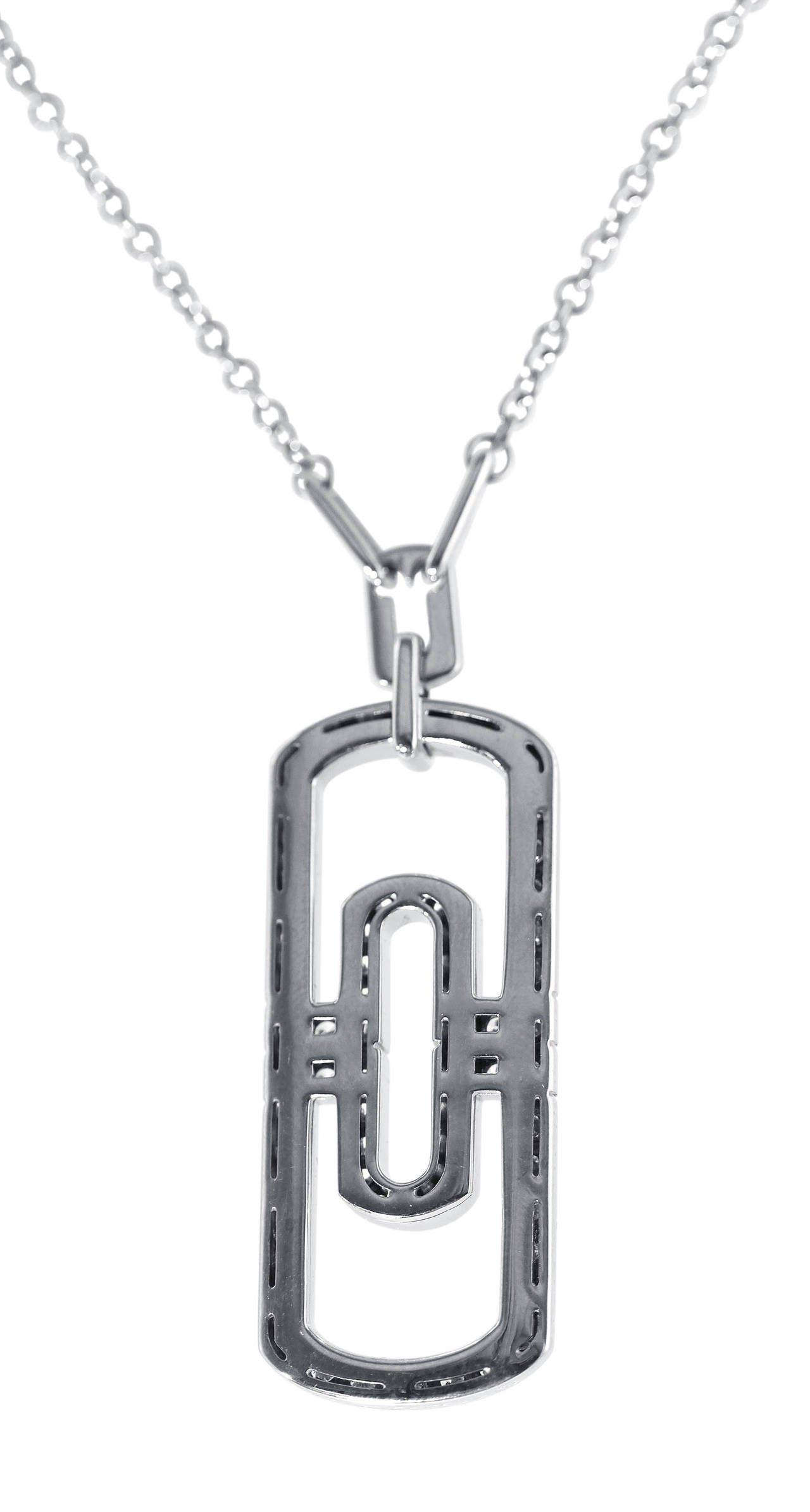 An 18 karat white gold and diamond 'Parentesi' pendant-necklace by Bulgari, Italy, the pendant of openwork rectangular geometric design set with 64 round diamonds weighing approximately 1.90 carats, completed with a white gold link chain, gross