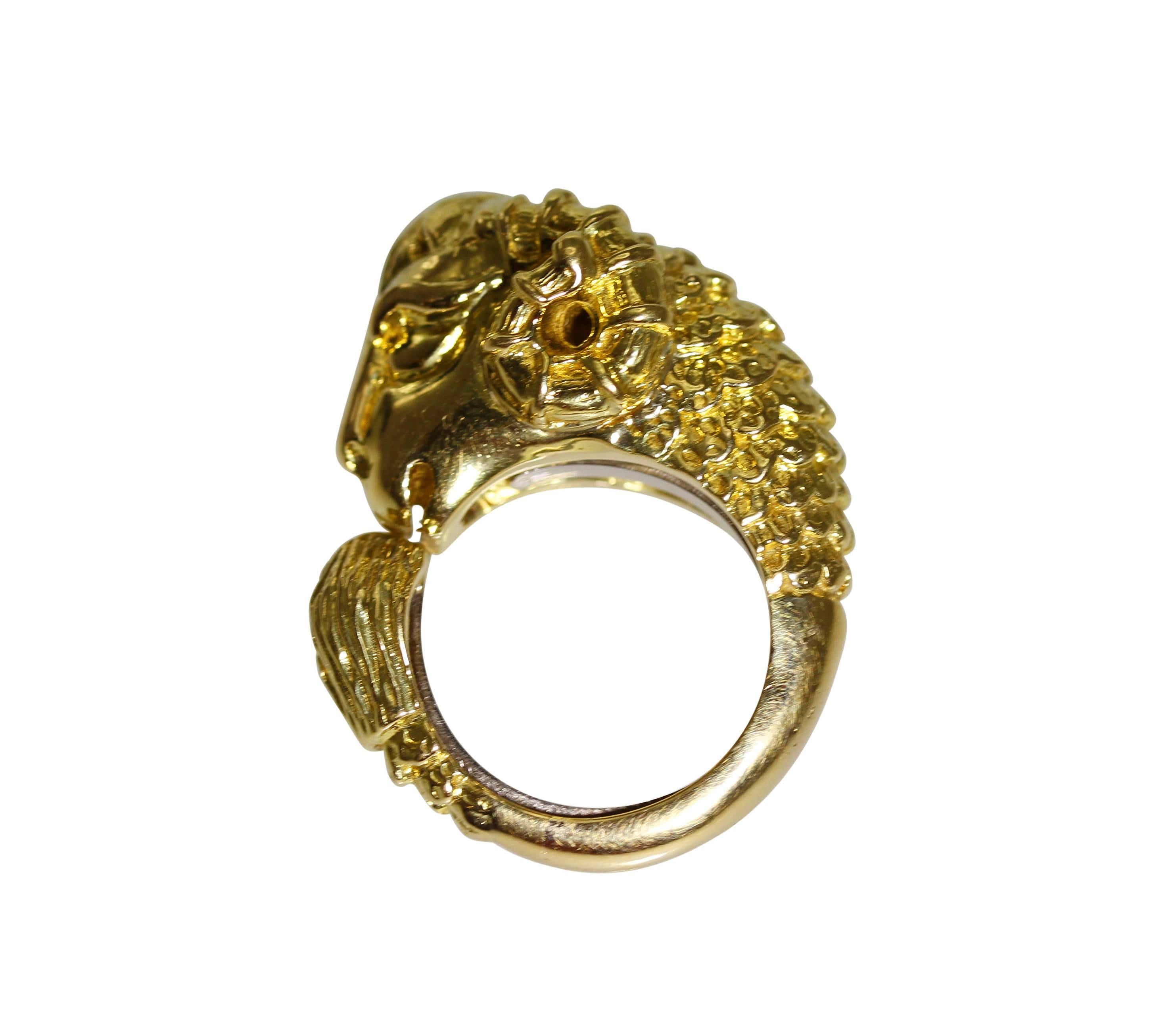 An 18 karat yellow gold ram's head ring by David Webb, designed as a ram's head with body wrapping around completed by a tail, gross weight 27.0 grams, size 6, measuring 1 1/4 by 1 by 1/2 inches.