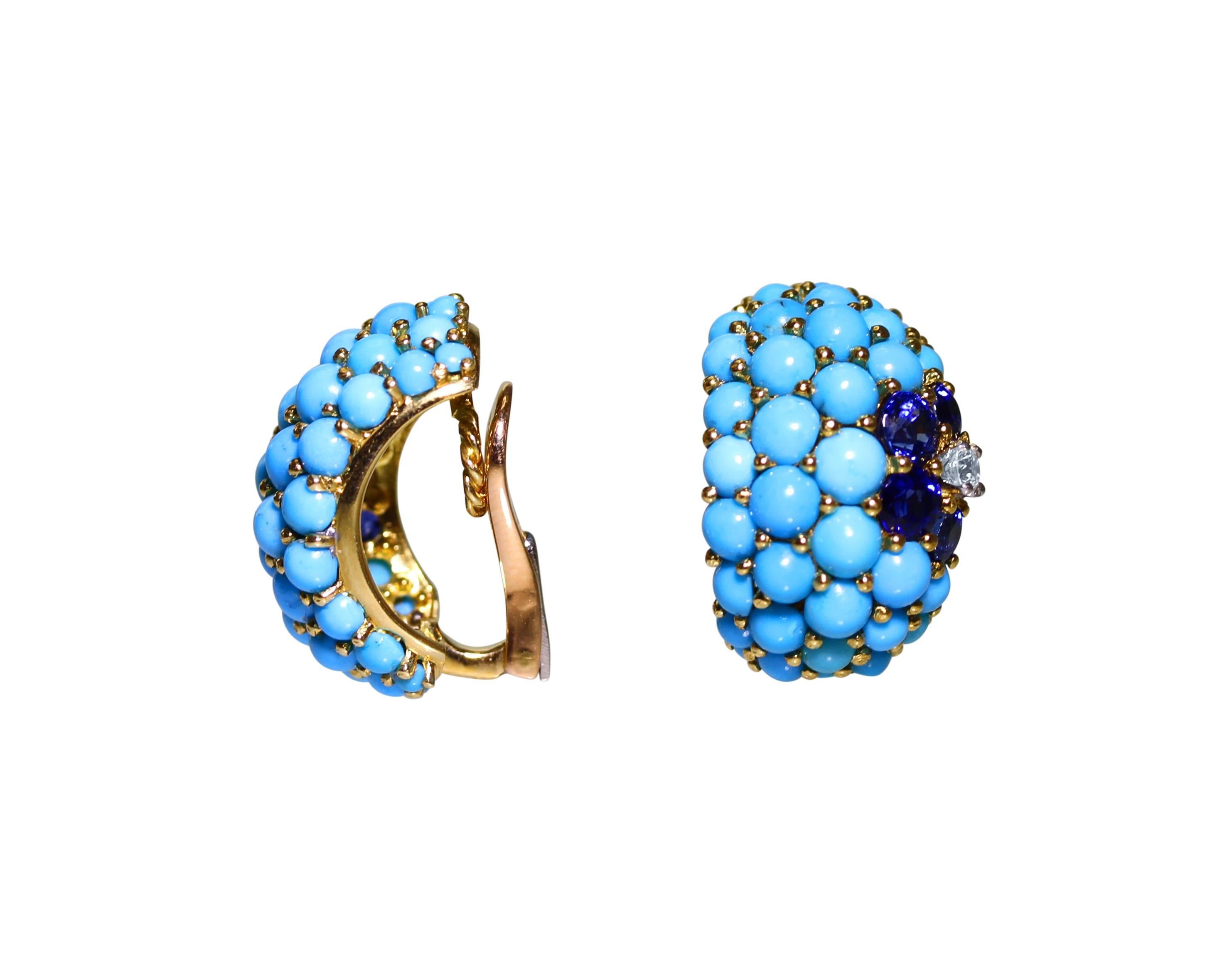 A pair of 18 karat gold, turquoise, sapphire and diamond earclips by Carvin French, of half-hoop bombe design accented by flowerheads, set with 70 turquoise cabochons, 8 round sapphires weighing approximately 2.50 carats, and 2 round diamonds