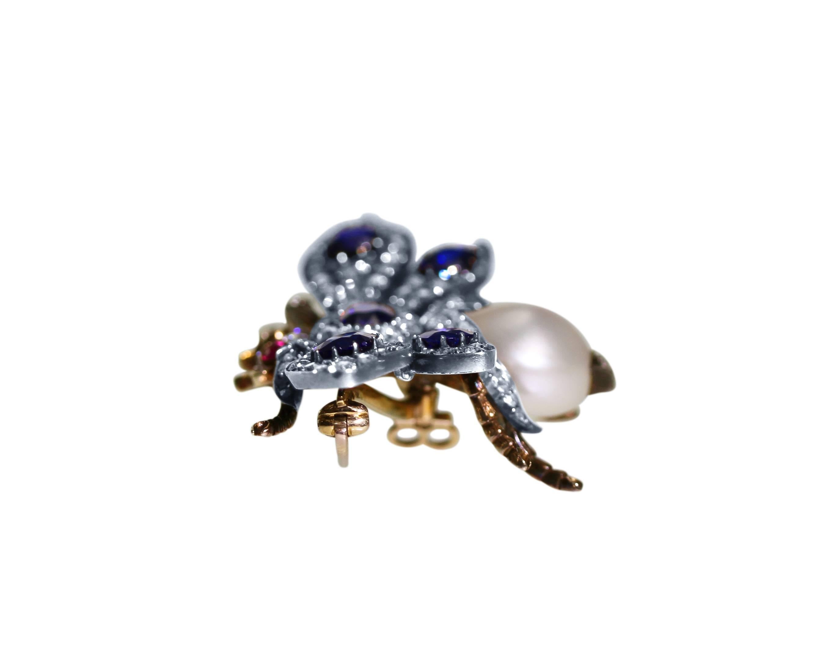 An antique silver-topped 14 karat gold, sapphire, diamond, pearl and ruby bumblebee brooch, designed as a standing bumblebee set with 5 deep bright blue natural sapphires weighing approximately 5.00 carats, 141 old-mine and rose-cut diamonds