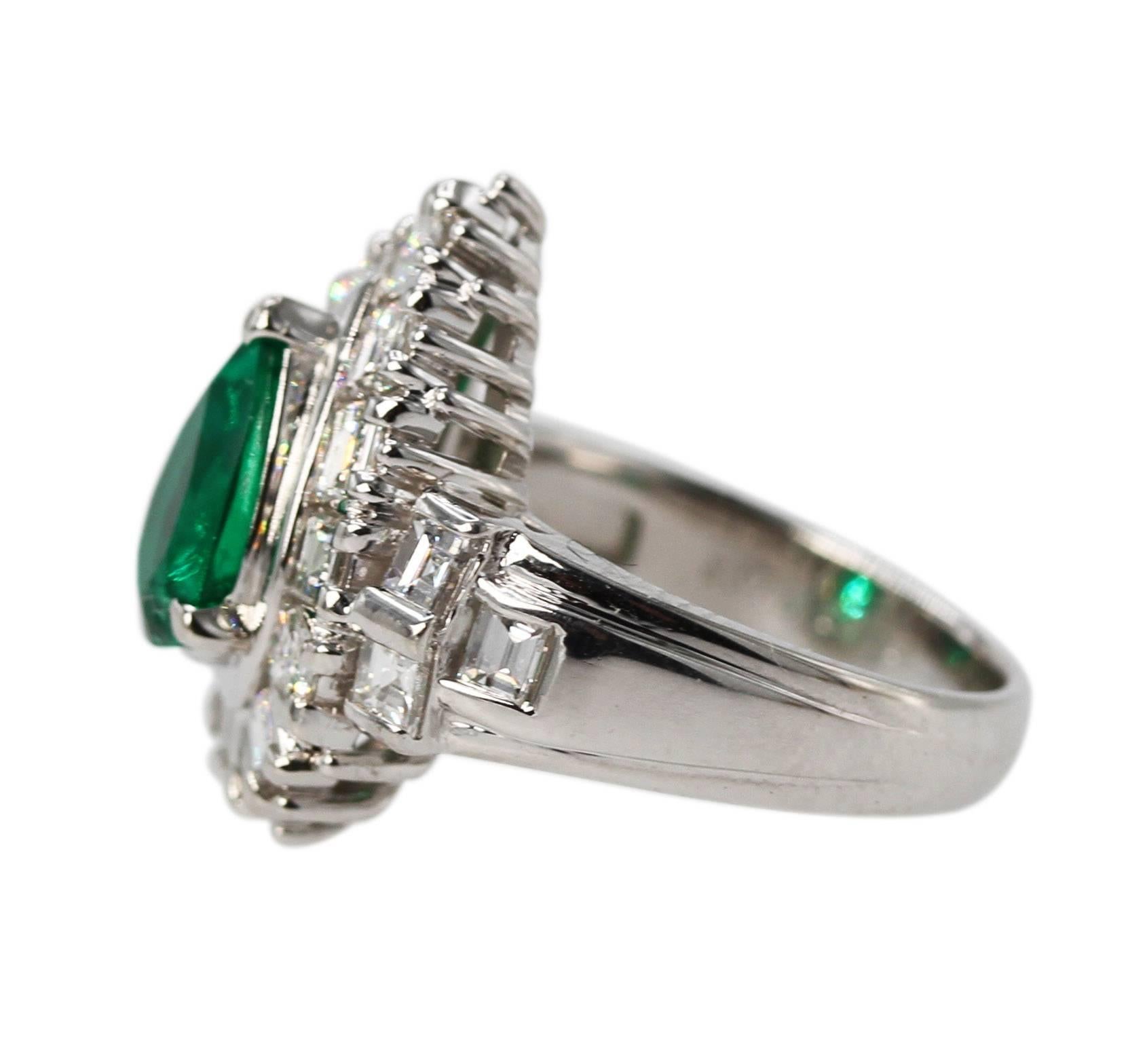 Platinum, Emerald and Diamond Ring
• Stamped PT900, E1.52 and D1.92
• Pear-shaped emerald weighing 1.52 carats 
• Accompanied by GIA gem report stating that the emerald is Columbian origin, F1
• 18 square step cut diamonds 1.92 carats
• Size 6 1/4