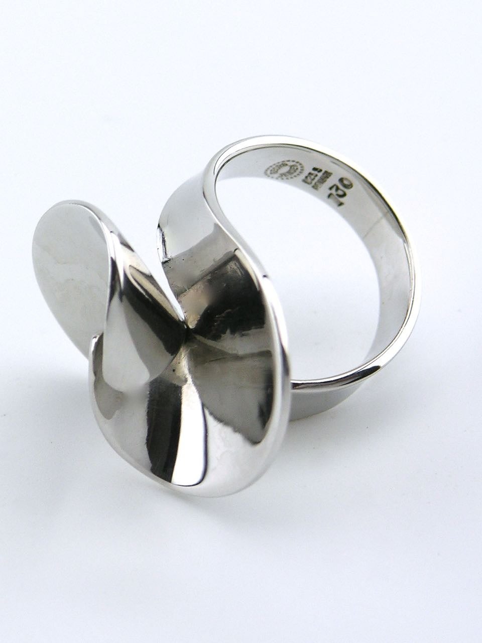 A ring in a wrap bypass design; each end with a flared and curved shape that interlocks with the other - marked for Georg Jensen design number 130

Current size K ( US 5.125) Can be resized if required