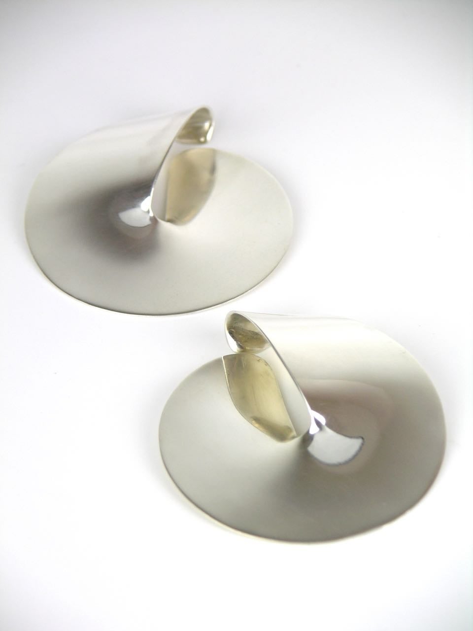 A very rare pair of elegant oversize Georg Jensen disc clip slings each earring consisting of a wonderful split disc shape that sits both in front and behind the ear; the top part of the disc rolling over to hook inside the ear and with a clip back
