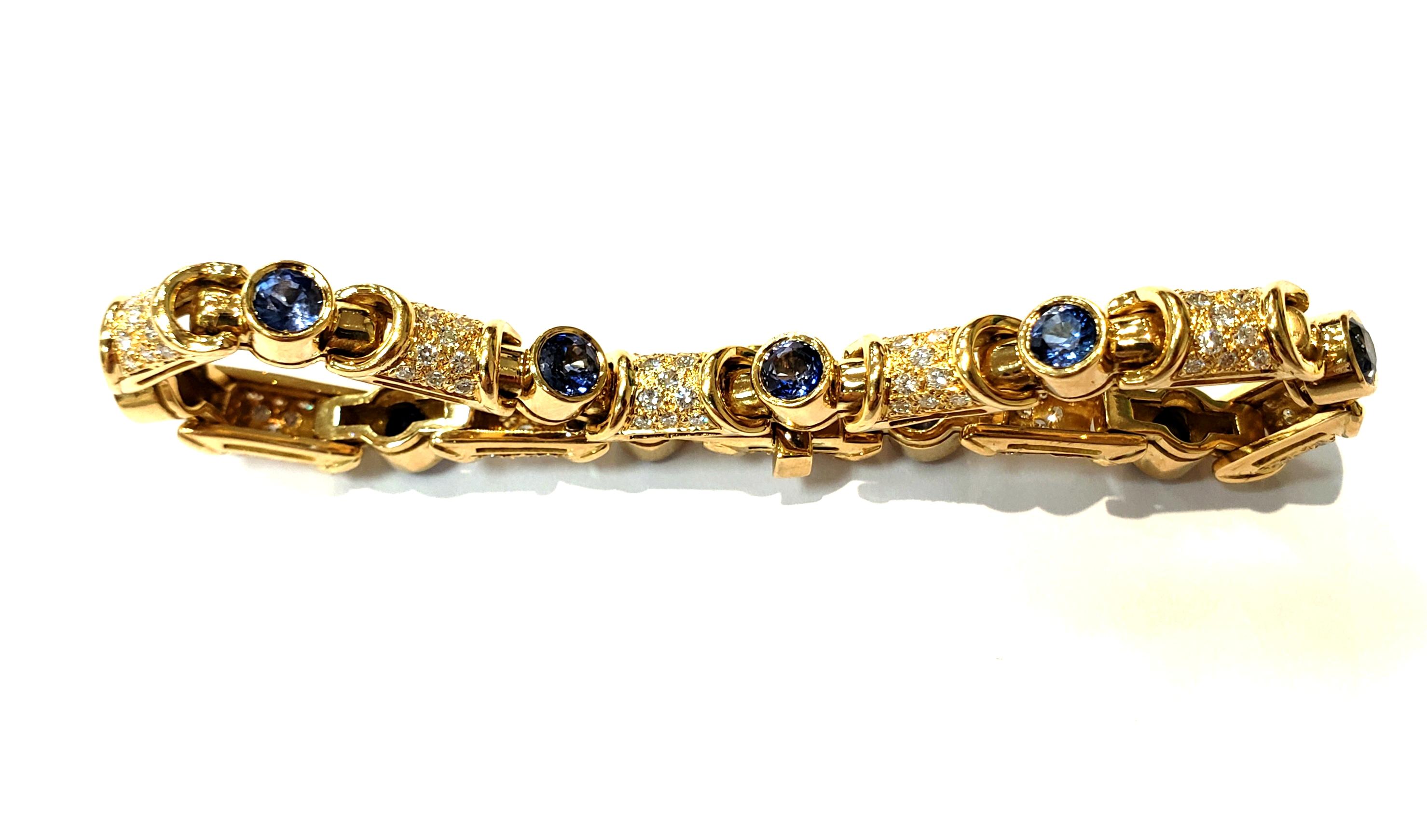 Contemporary 18 Karat Yellow Gold and Diamond Link Bracelet with Bezel Set Blue Sapphires For Sale