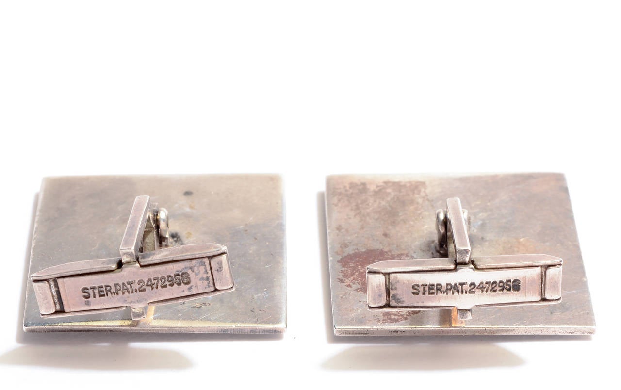 Charming sterling silver cufflinks for the male or female sailor. They cleverly convey the boats and water while reducing them to their most basic elements. The boat and water are applied on an oxidized ground.

Measurements are 15/16