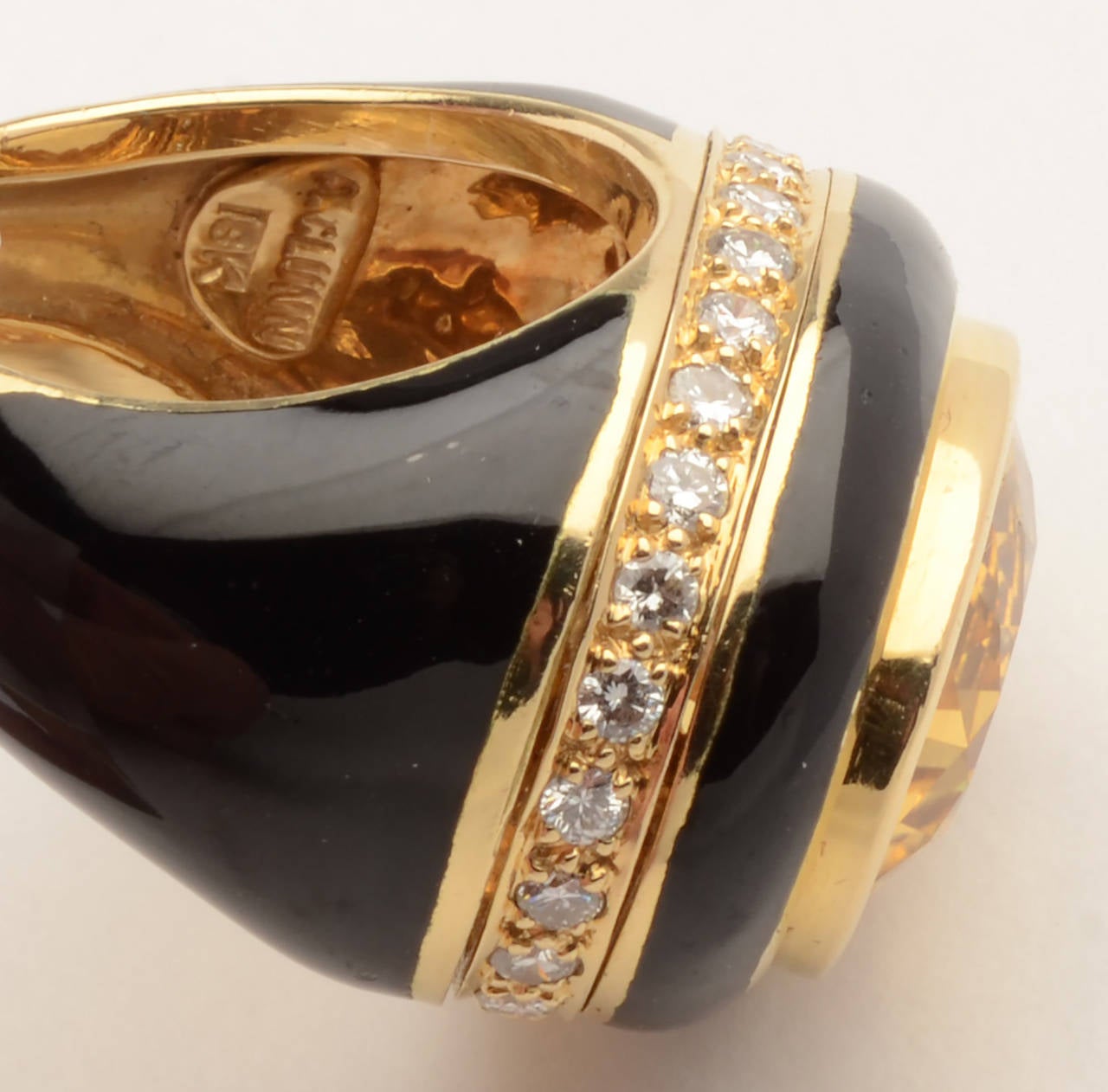This stunning and impressive ring is by American designer, Andrew Clunn. An oval citrine is surrounded by a band of black onyx. A band of diamonds is below that with onyx below the diamonds. The citrine measures 11/16