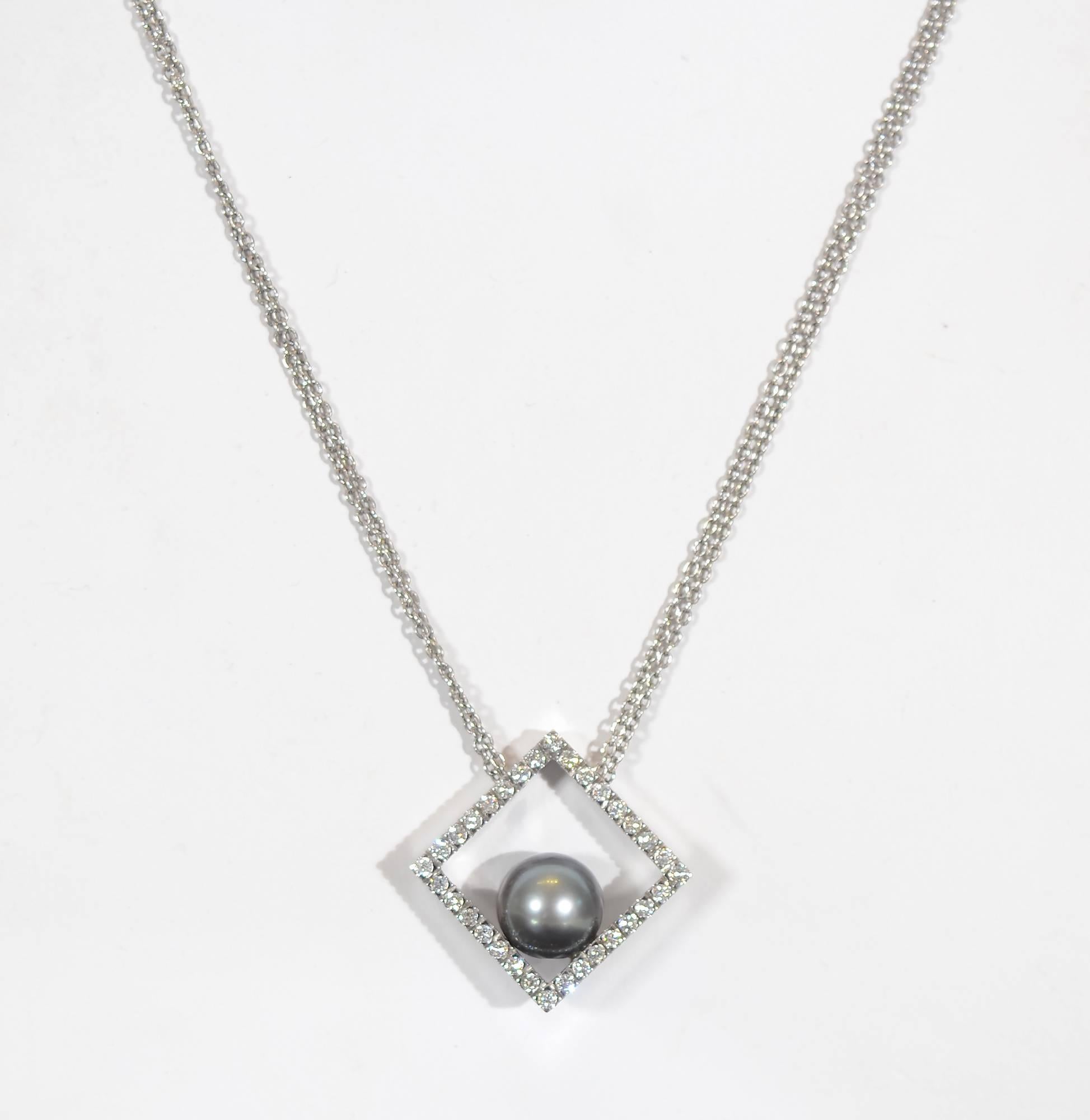 Lovely 18 karat white gold pendant with diamonds by Italian jeweler, Damiani. In a corner of the square pendant is a 9 mm black pearl. The square measures 3/4