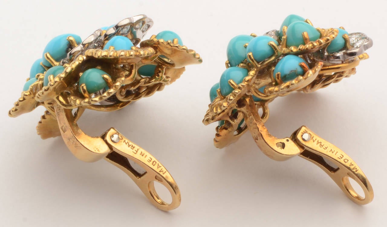 Clusters of turquoise are hugged by arcs of gold and diamonds. The stones are nicely tiered to give dimension to the earrings. They measure 1 1/8