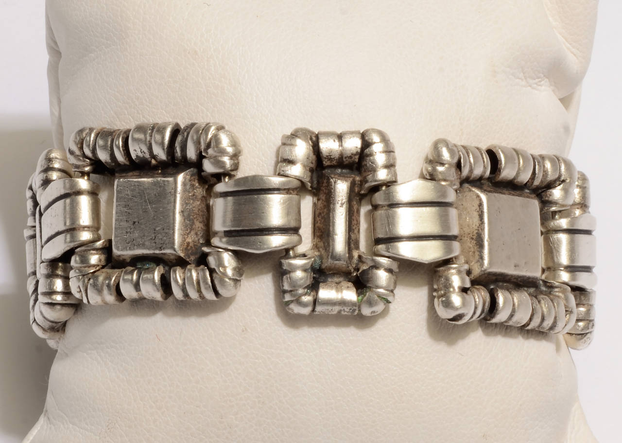 This ornamented squares bracelet by silver master William Spratling is not often seen.
Alternating squares and rectangles have a wrapped circular design around them.
Measurements are 3/4