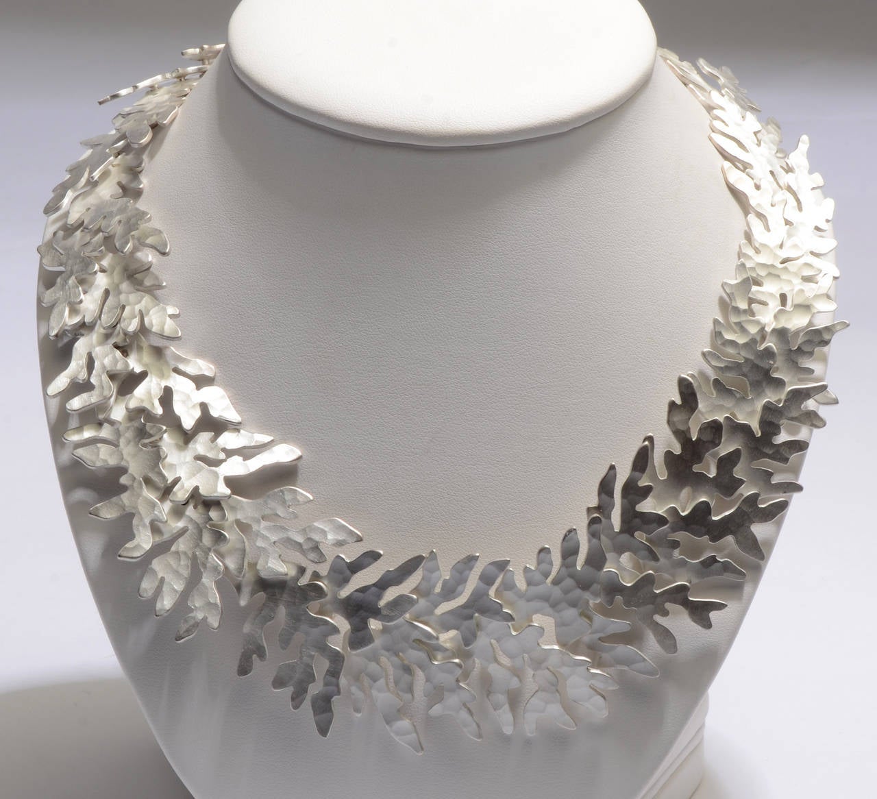 This wonderful 950 silver (higher quality than sterling) necklace by Eduardo Herrera calls two mind two very different images. It looks like coral as well as the cut out designs of Henri Matisse.
The links are hammered. They are 1 1/2