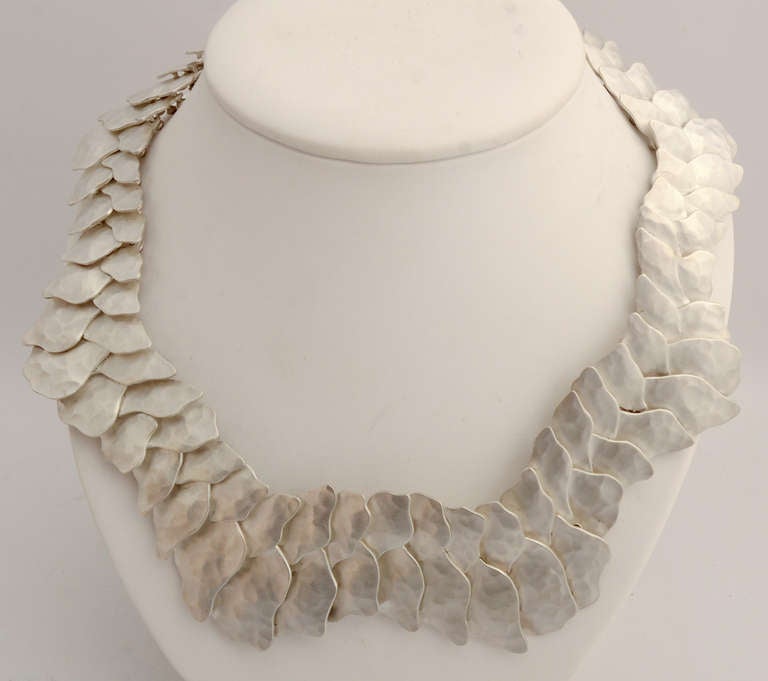 This is the latest necklace by Mexican architect turned jeweler, Eduardo Herrera in his reptilian series. The overlapping asymmetrical links move easily, making it very comfortable to wear. Herrera's architectural background is clearly evident in