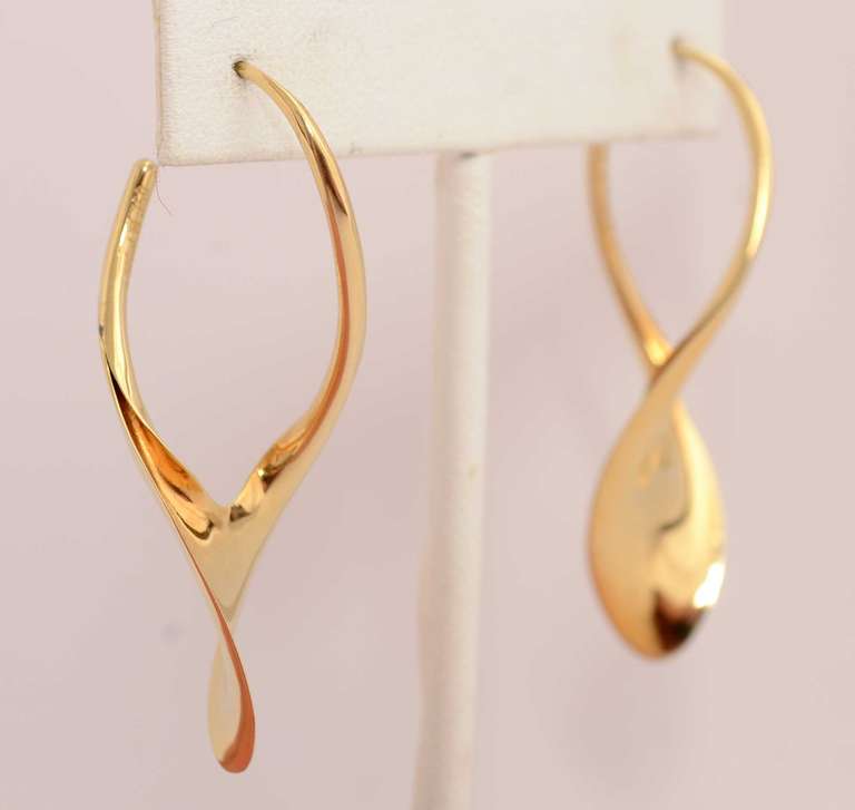 Wishbone shaped 18 karat gold earrings by American goldsmith, Michael Good. Good is known for his very sculptural work and his ability to twist the metal to create new surfaces. His jewelry is particularly fluid and easy to wear. The earrings