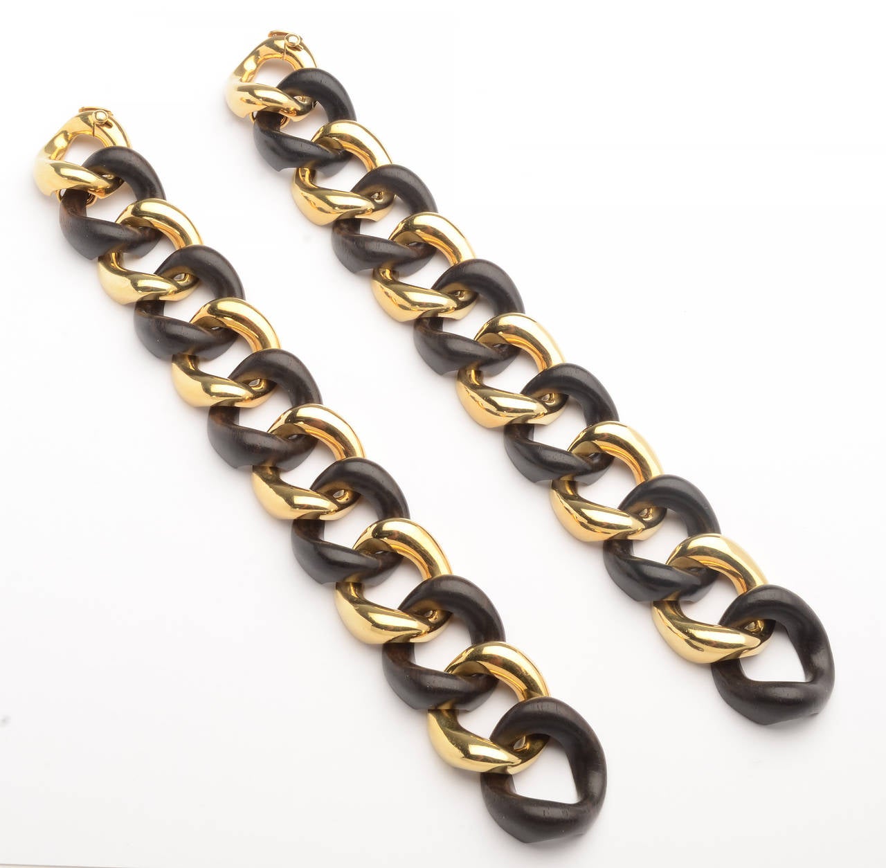 Two Seaman Schepps classic curbchain link bracelets in 18 karat gold and ebony. They are being offered as a pair as the whole is more than the sum of the parts. Each is terrific on its own but they make a smashing statement when worn together.