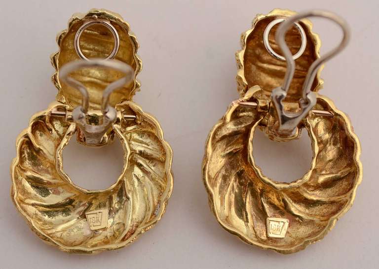 Unusual Doorknocker earrings of 18 karat gold with both swirled and textured patterning. Clip backs. Measurements are 1 1/2