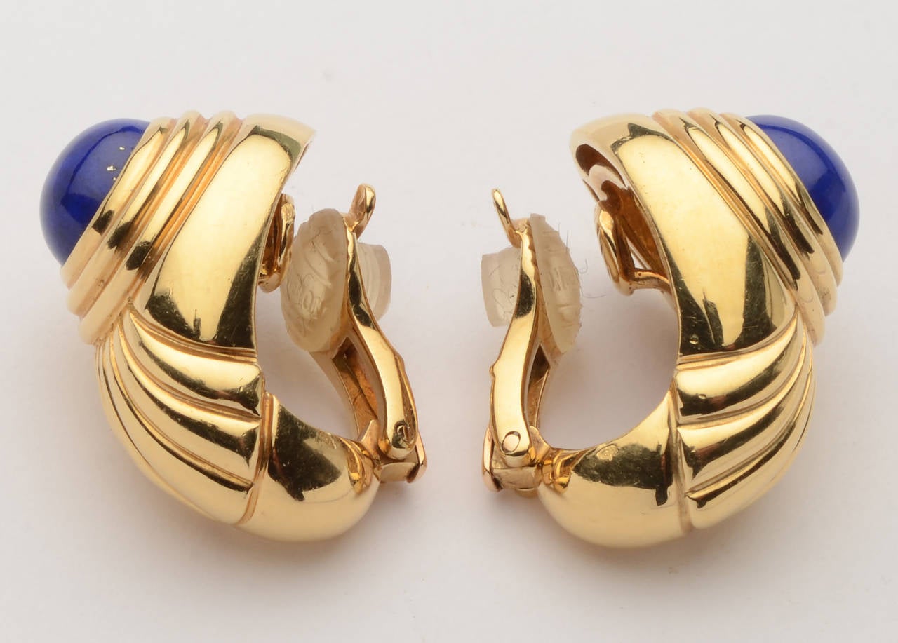 Tailored and chic 18 karat gold Boucheron earrings with oval lapis stones. Clip backs. Measurements are 1