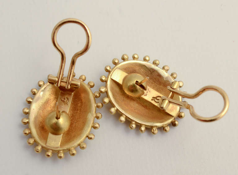 Simple and elegant hammered gold earrings by Elizabeth Locke. The convex ovals are surrounded by tiny gold balls. The backs are the collapsible posts and clips that Locke always uses. Measurements are 1