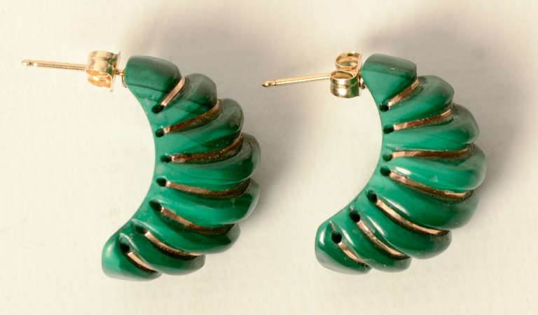 Unusual shrimp earrings combining carved, swirled rows of malachite with bands of 14 karat gold. Posts for pierced ears. Measure 13/16