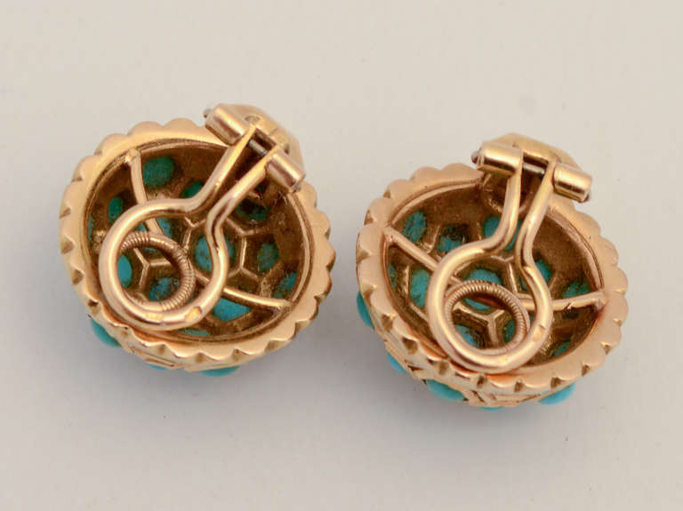 Domed 18 karat ear clips encrusted with turquoise stones. The design is enhanced by setting the round stones within hexagonal shaped bezels. The earrings are 11/16