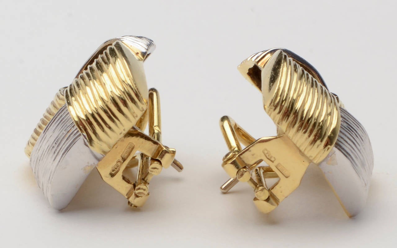 Woven bands of yellow and white gold are nicely textured in these 18 karat gold earrings by Roberto Coin. Omega backs; made circa 1980.