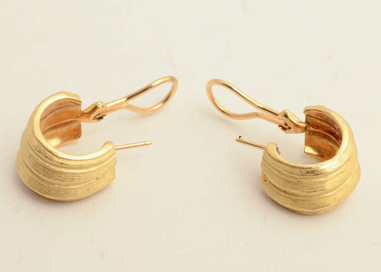 Nicely sculpted and textured 18 karat gold hoop earrings by Tiffany. They measure 7/16