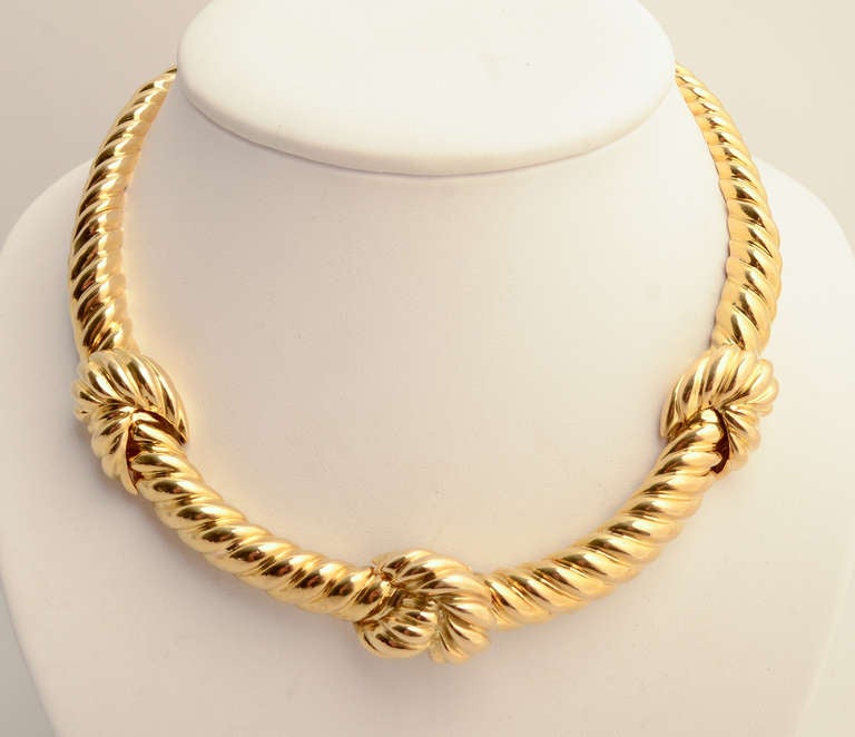 Wonderfully versatile 18 karat gold choker necklace by David Webb. It can easily be worn for day or evening. A twisted gold wide band is enhanced by four knots, the fourth hiding the clasp. The band is 1/2