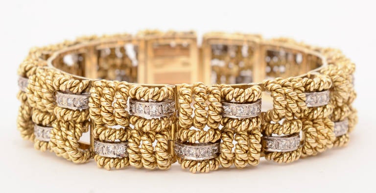 Unusual gold and diamond  bracelet in a basketweave pattern. Each arched piece of gold is like a twisted rope making for a wonderful texture to the bracelet. The inner diameter is 2 1/4