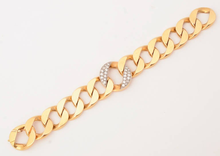 Fabulous Cartier curb chain link bracelet by Cartier with a larger central link filled with diamonds. The bracelet is 7 5/8
